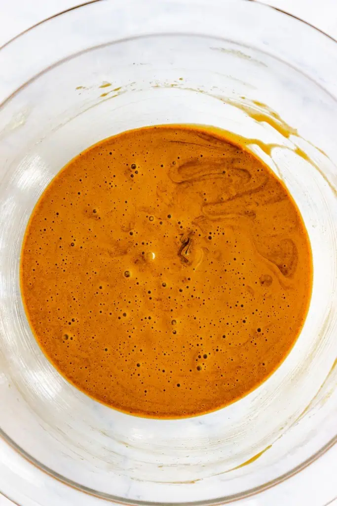 Glass bowl with egg and spice mixture.