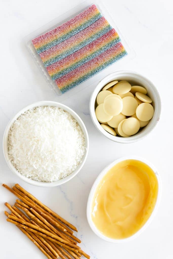 Snowman truffle ingredients on a marble countertop.