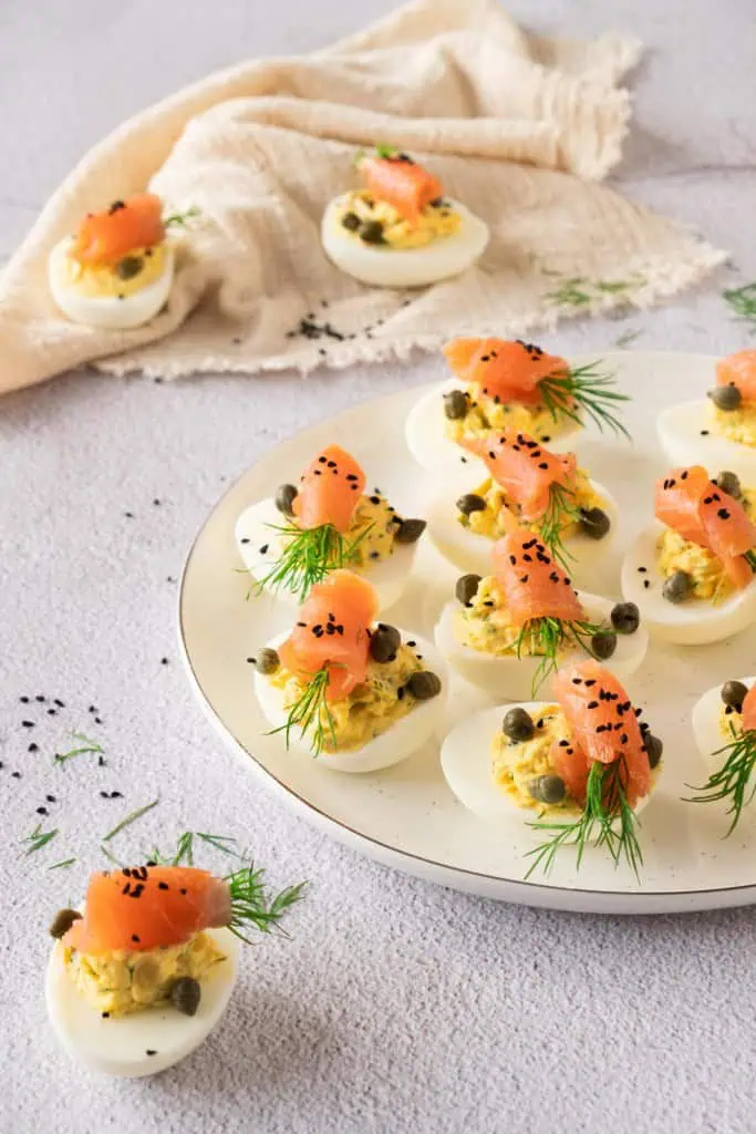 Smoked salmon deviled eggs on a white serving plate.