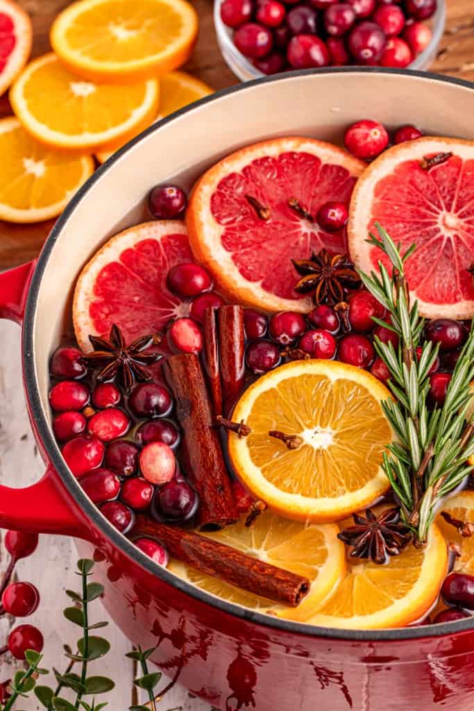 Christmas simmering pot with extra ingredients in the background.