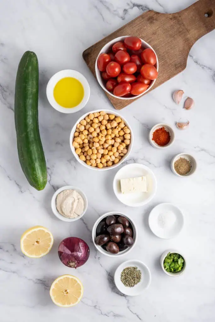 Mediterranean hummus recipe ingredients on a marble countertop.