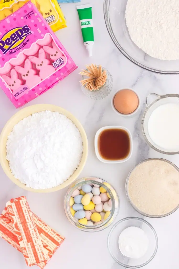 Ingredients to make peeps cupcakes on a marble countertop.
