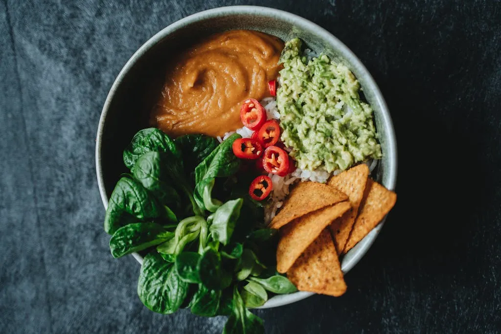 Delicious vegan bowl featuring avocado, rice, and fresh greens perfect for a healthy meal.