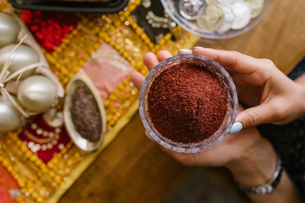 Top view of hands holding spices over Nowruz decorations, symbolizing Persian New Year.