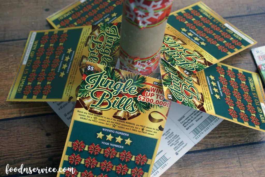 place pieces of tape in the middle of the ticket and join to the toilet paper rolls. Be sure to space them out a little bit.