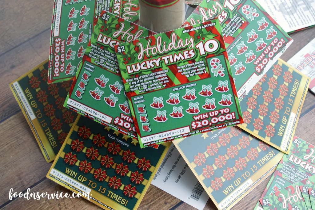 Then add a layer of the $2 lottery scratch off tickets. You want to come up almost an inch. Leave some space for the tickets going up the toilet paper roll. You're going to need. 