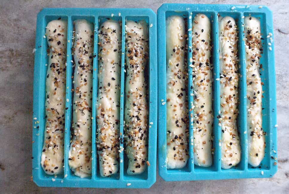 bagel sticks in blue silicone molds with everything but the bagel seasonings on them