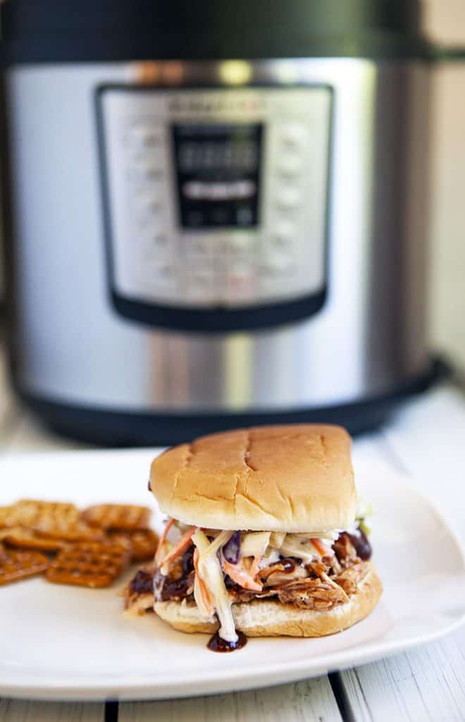 instant pot bbq chicken sandwich on a plate in front of an instant pot machine