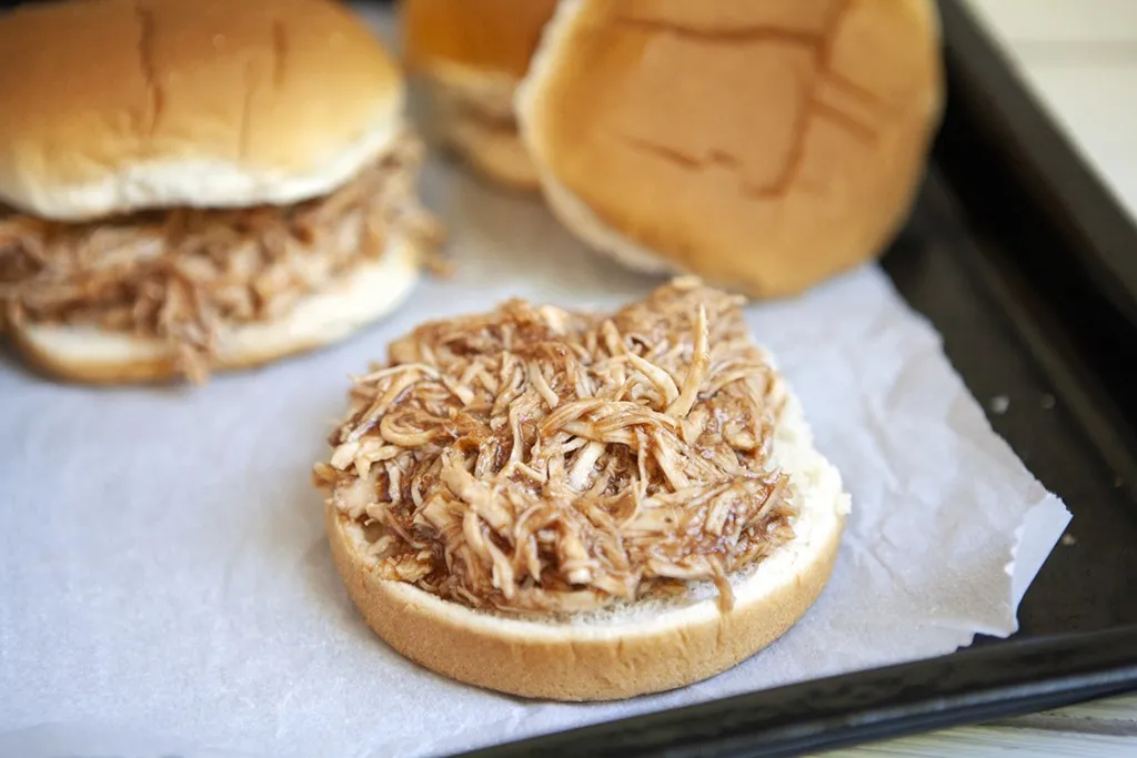 open faced instant pot bbq chicken sandwich on a tray