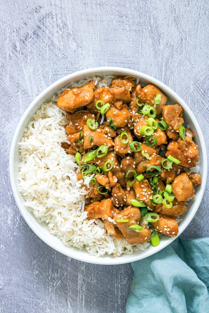 Close up view of my instant pot sesame chicken with green napkin on a gray background
