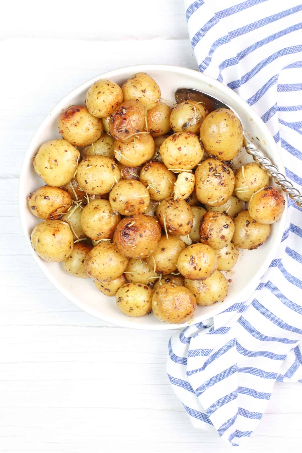 instant pot butter potatoes with herbs in a white bowl