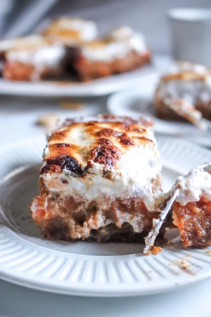 Sweet potato pie bars on a white plate with fork
