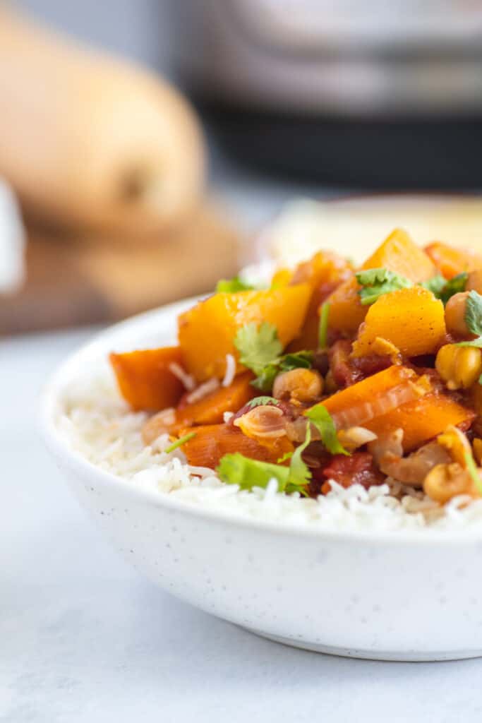 instant pot vegetarian moroccan stew in a white bowl over rice