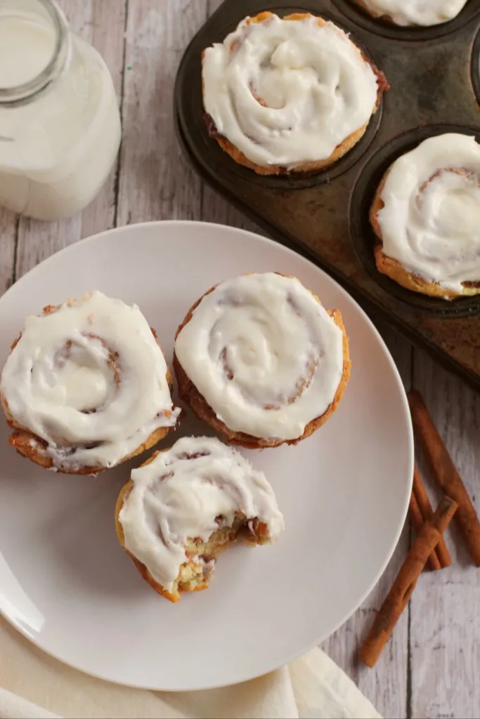 overhead shot of cinnamon rolls on a white plate