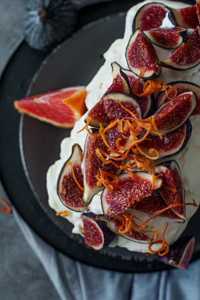fresh figs sliced on a fig loaf cake recipe on a dark gray plate