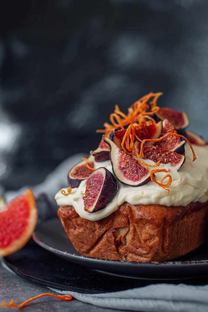 fresh grated orange peelings on a fig loaf cake with cream cheese icing