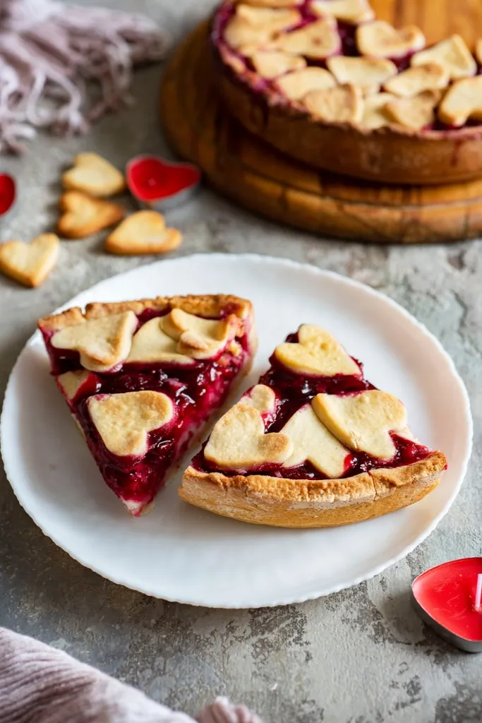a cherry tart with cut out hearts on top