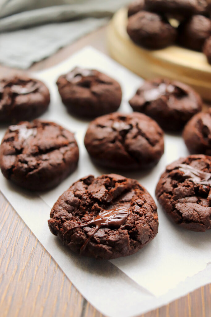 easy double chocolate cookies on a piece of white parchment paper