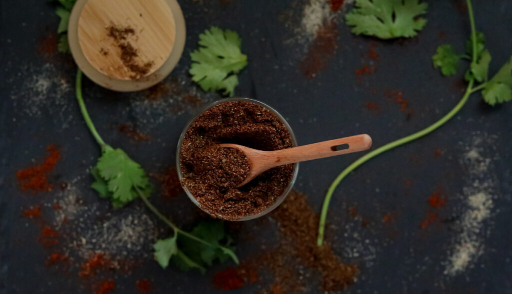 homemade mild taco seasoning with a wooden spoon and cilantro