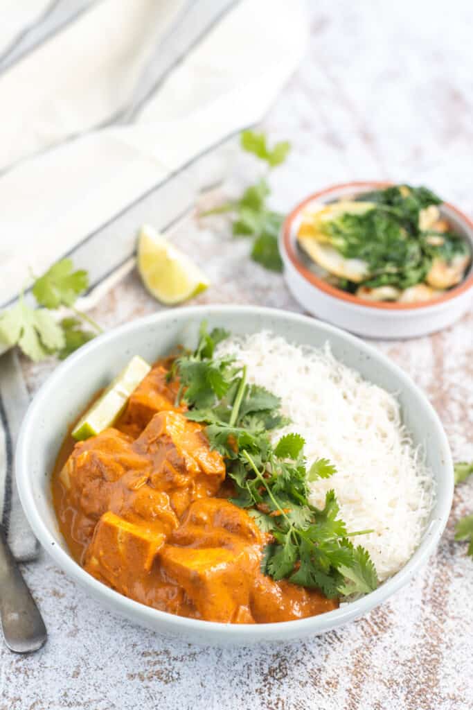 instant pot tofu curry in a bowl with cilantro and white rice