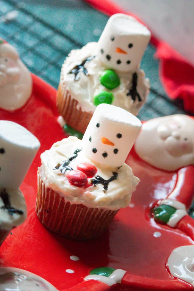 melting snowmen cupcakes on a wire rack