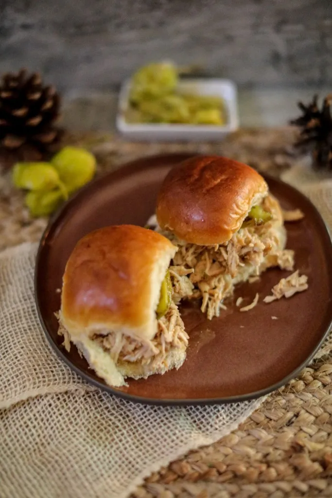 two mississippi chicken sliders on a brown plate side by side
