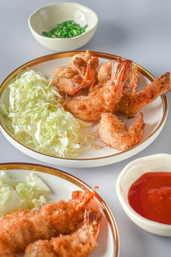 a plate of panko fried shrimp and shredded lettuce