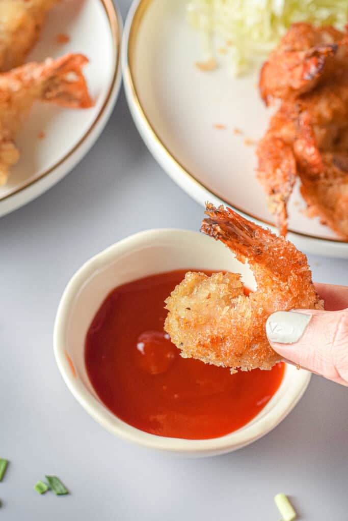 a bowl of cocktail sauce with panko shrimp