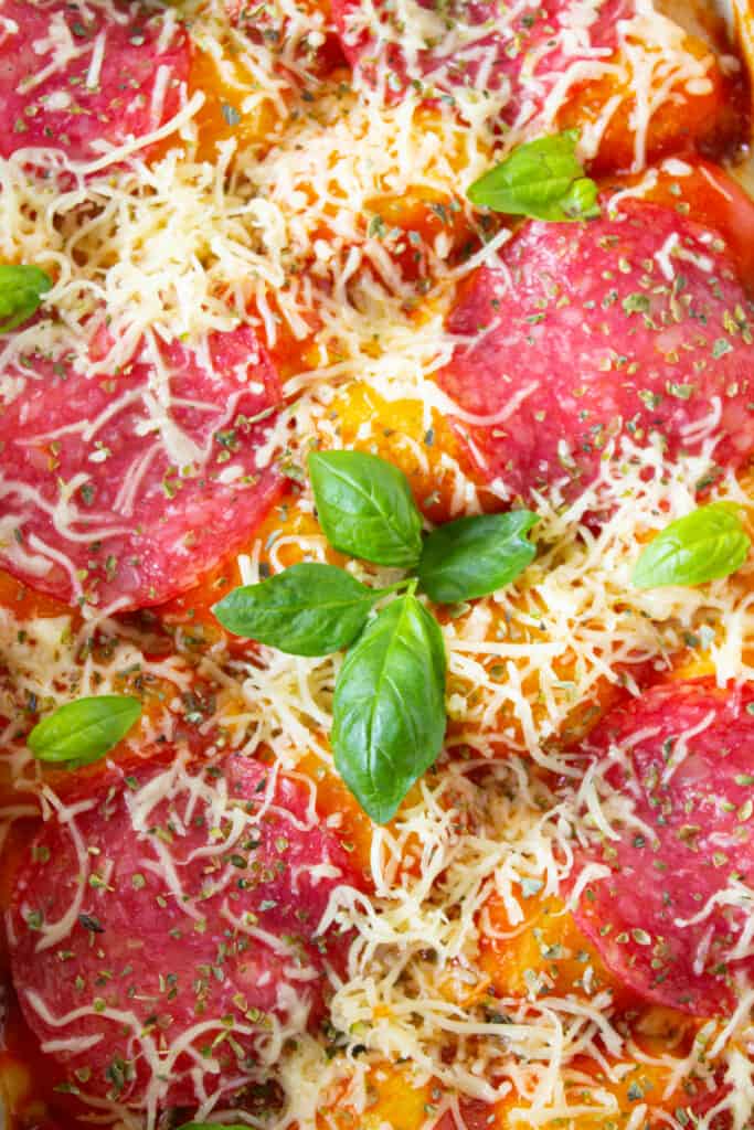 close up view of pizza gnocchi casserole with fresh basil