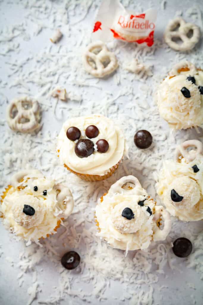 overhead shot of polar bear christmas cupcakes with white chocolate pretzels