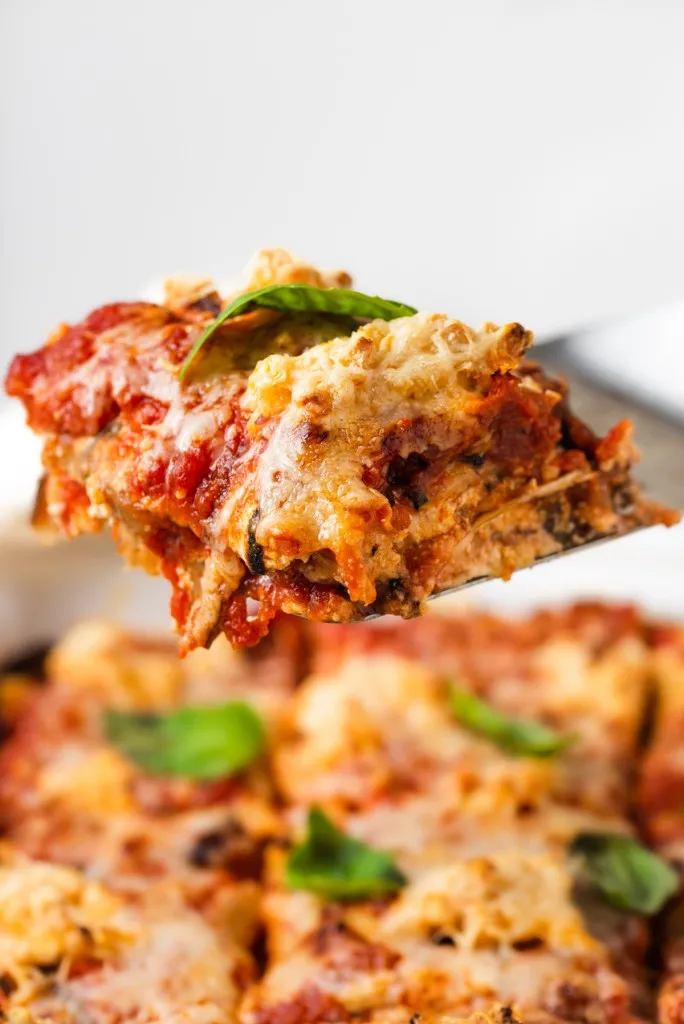 another shot of vegan lasagna slice on a metal spatula