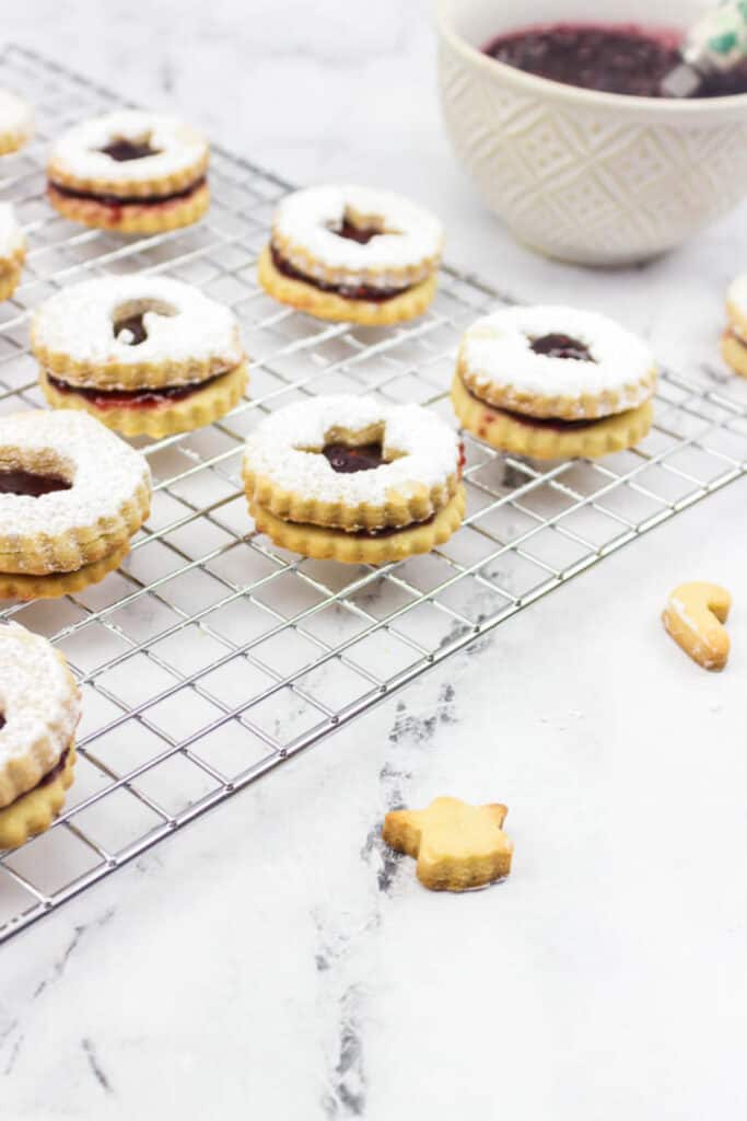 linzer cookies made for christmas on a coolie rack