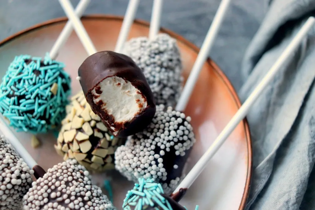 bite taken out of a chocolate covered marshmallow