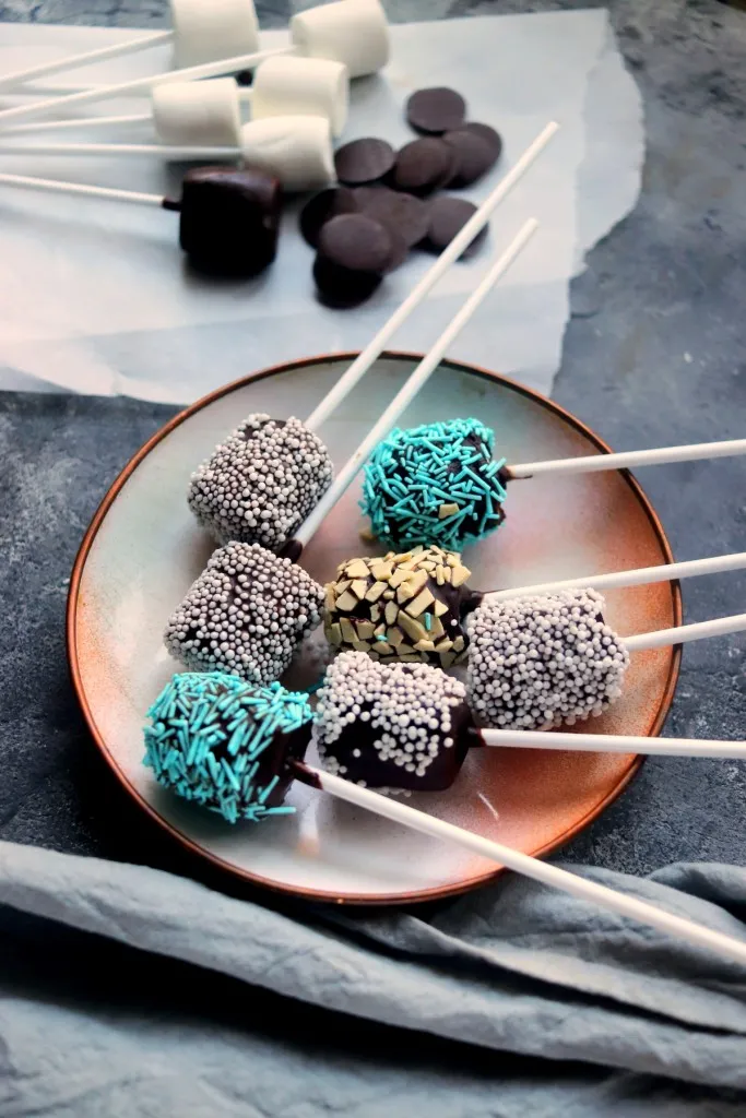 main image of chocolate covered marshmallows with melting chocolate and marshmallows in the background