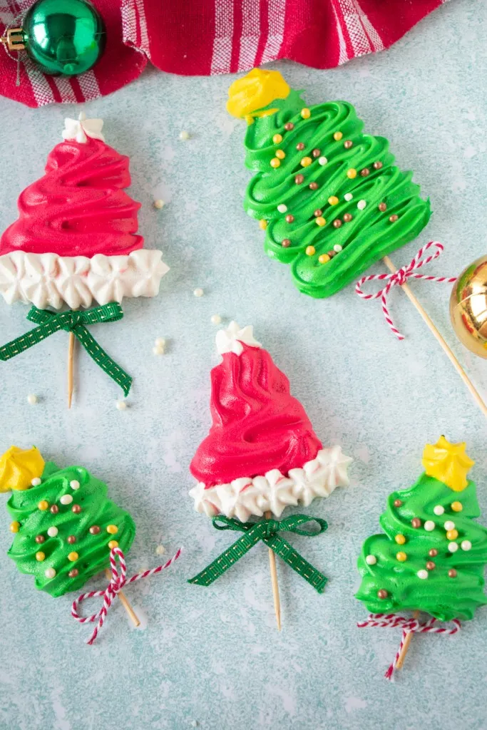 overhead photo of different christmas meringue pops on a flat surface