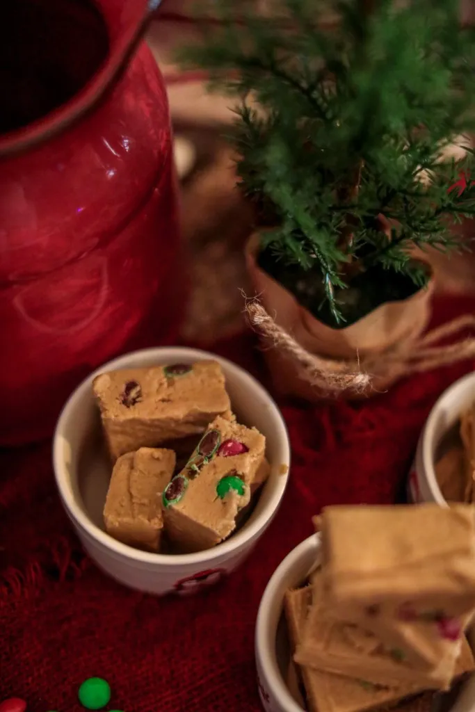 easy to make peanut butter holiday fudge in white bowls on a red background