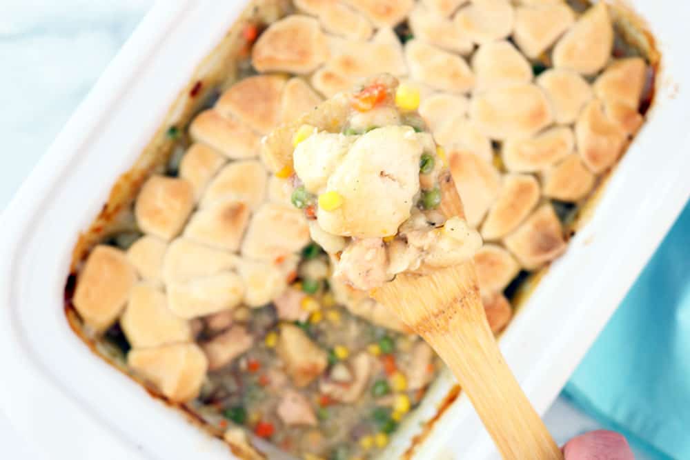chicken pot pie on a wooden spoon over the main casserole image