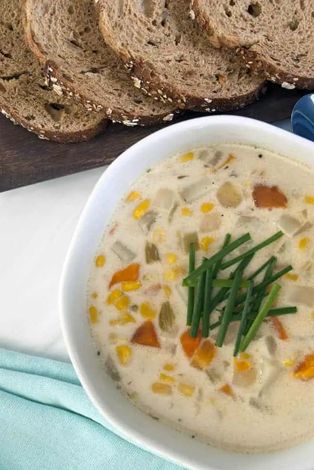 close up shot of corn chowder with diced green onions