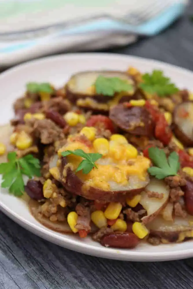 side view of slow cooker cowboy potatoes with fresh parsley