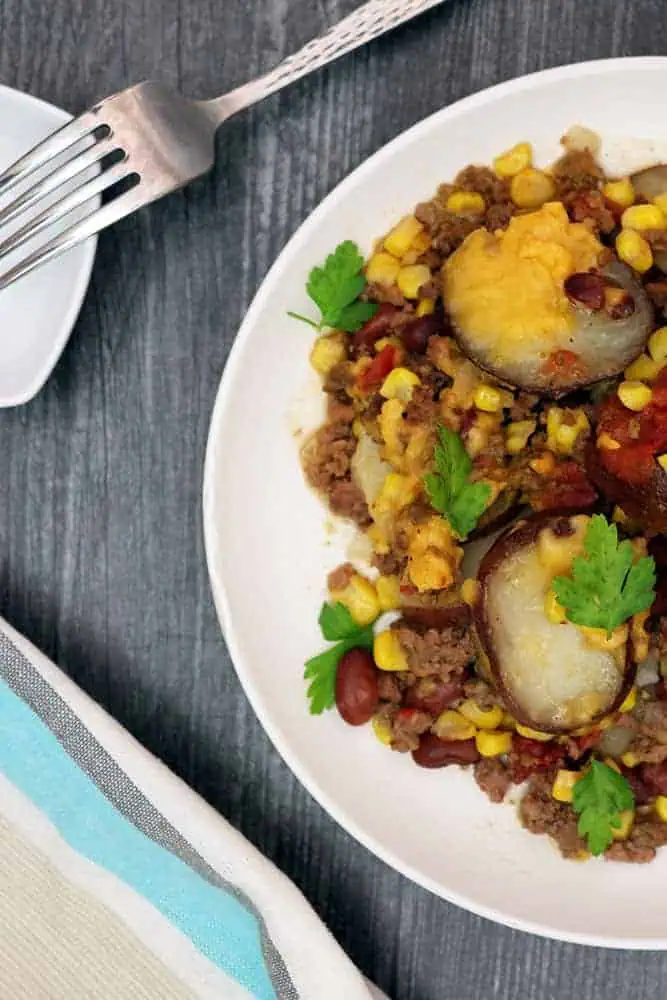overhead shot of cowboy potatoes made in a crockpot on a white plate