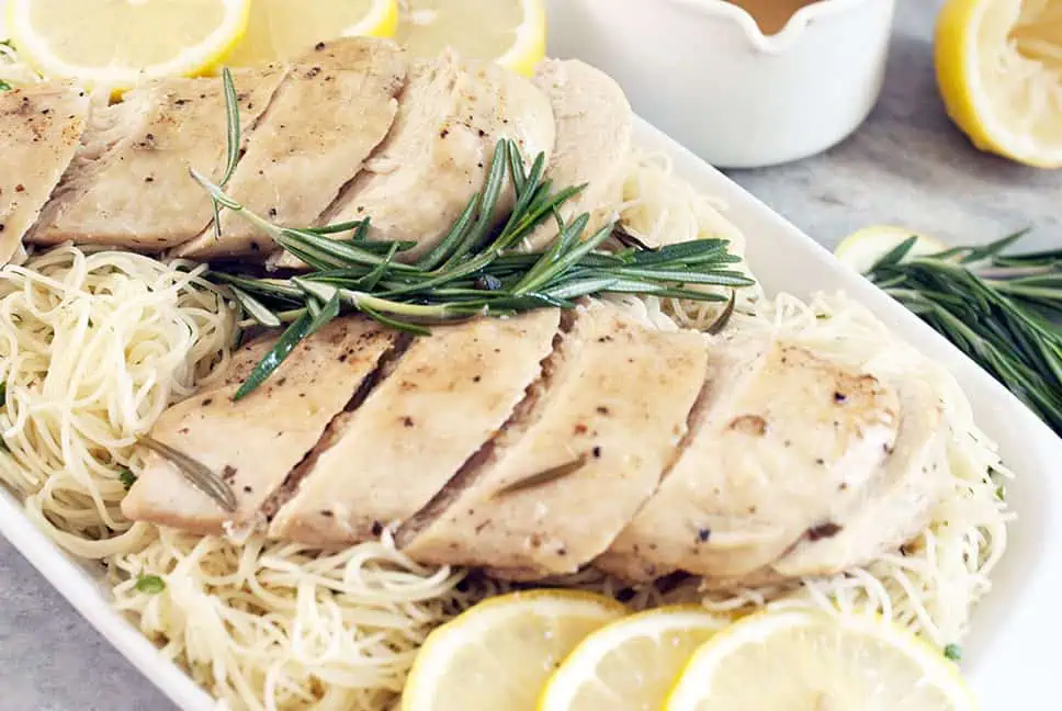 sliced chicken over angel hair pasta with lemon butter sauce