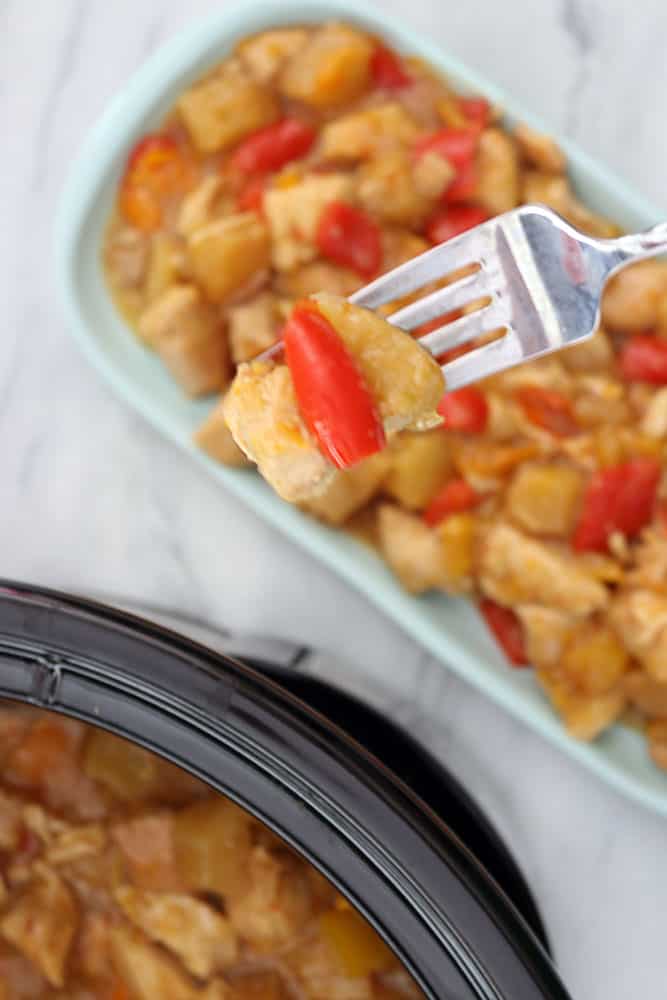slow cooker pineapple chicken on a fork