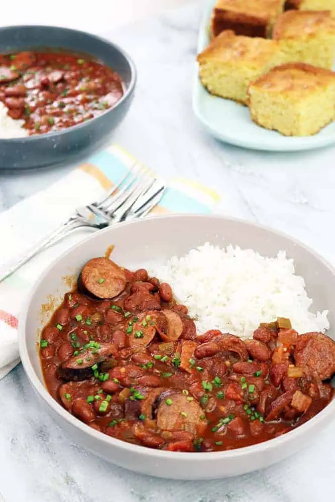 close up shot of red beans and rices in a light grey bowl