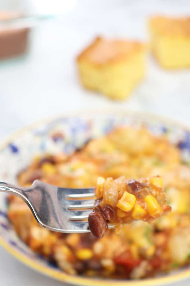 tater tot casserole on a fork showing corn and beans