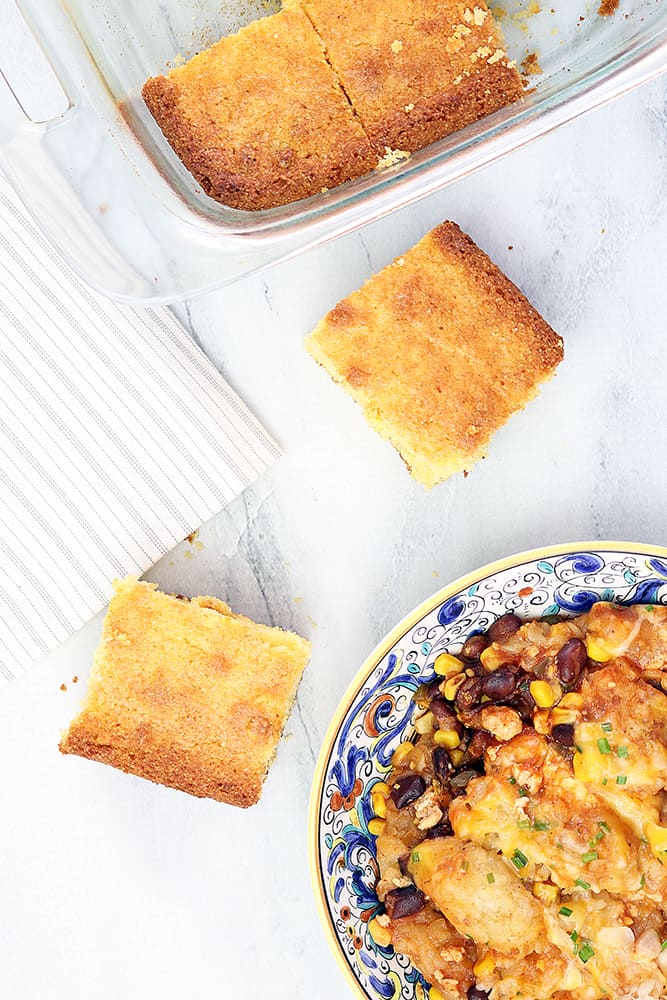 overhead shot of tater tot casserole made in a slow cooker with fresh cornbread