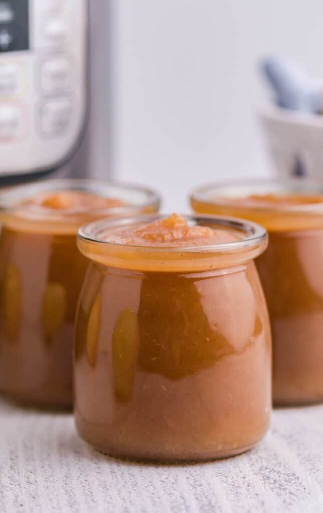 side view of instant pot made apple butter in mason jars