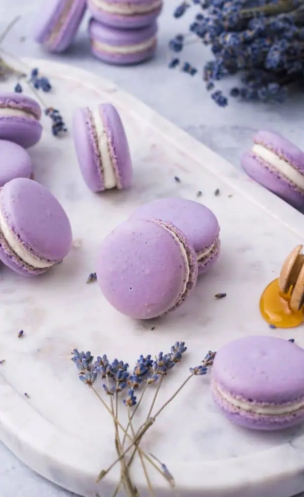 lavender macarons on a granite plate and fresh lavender