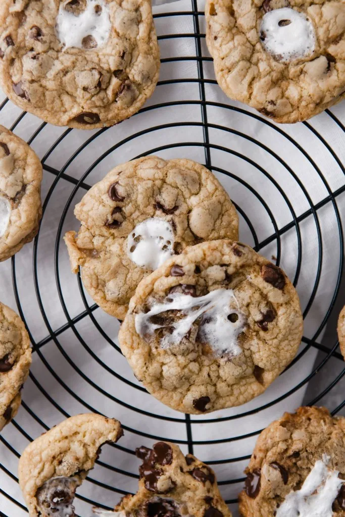 overhead shot of marshmallow chocolate chip cookies on a wire cooling wrack
