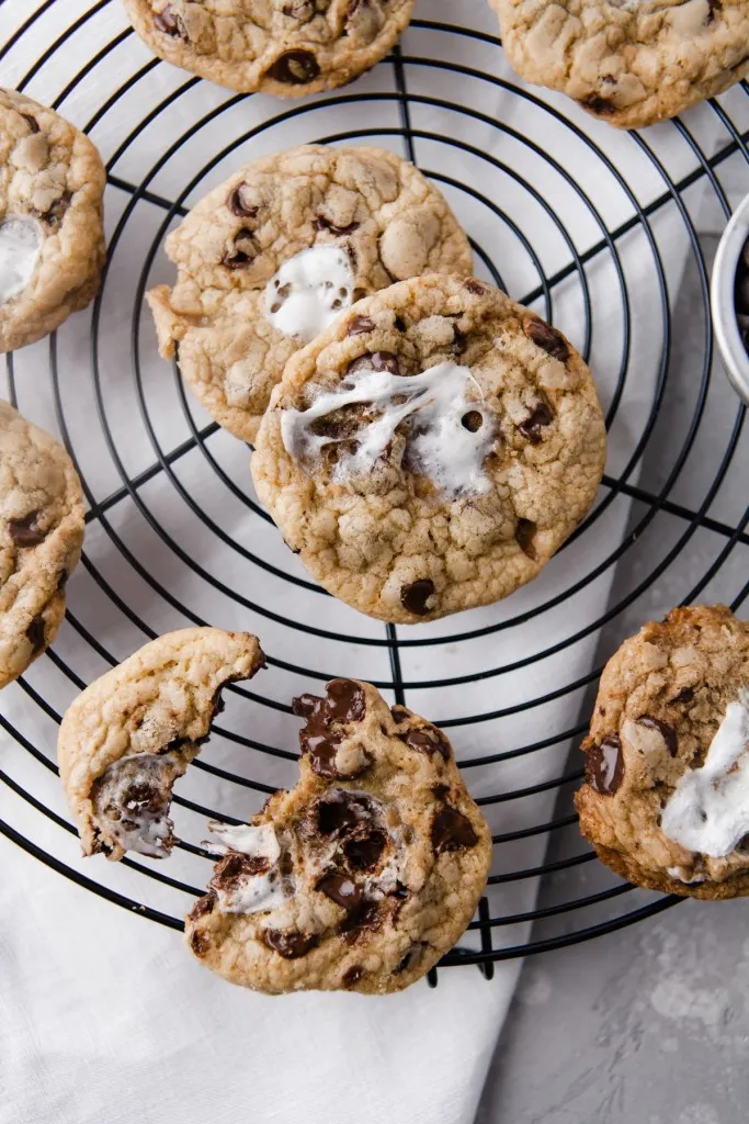 marshmallow chocolate chip cookies on a wire cooling wrack on a concrete background