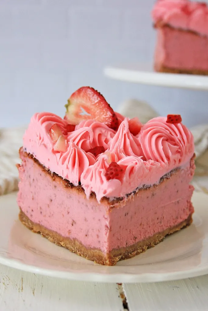 a slice of strawberry cheesecake made in the air fryer on a ceramic plate